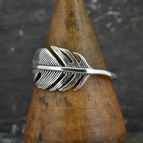 sterling silver wide feather ring on side