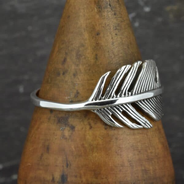 sterling silver wide feather ring on side