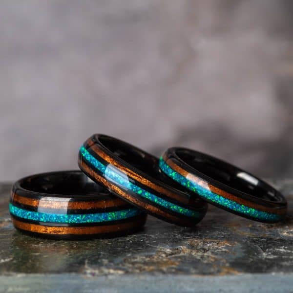 Opal and Koa wood black tungsten rings.