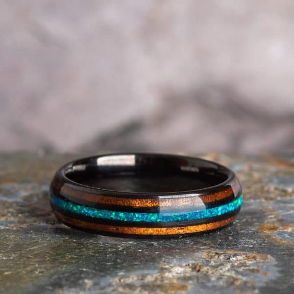 Opal and Koa Wood Black Tungsten Ring standing on side